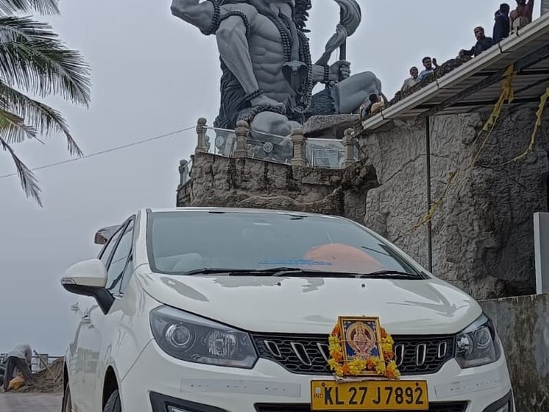 Cab passing by a shiva structure statue