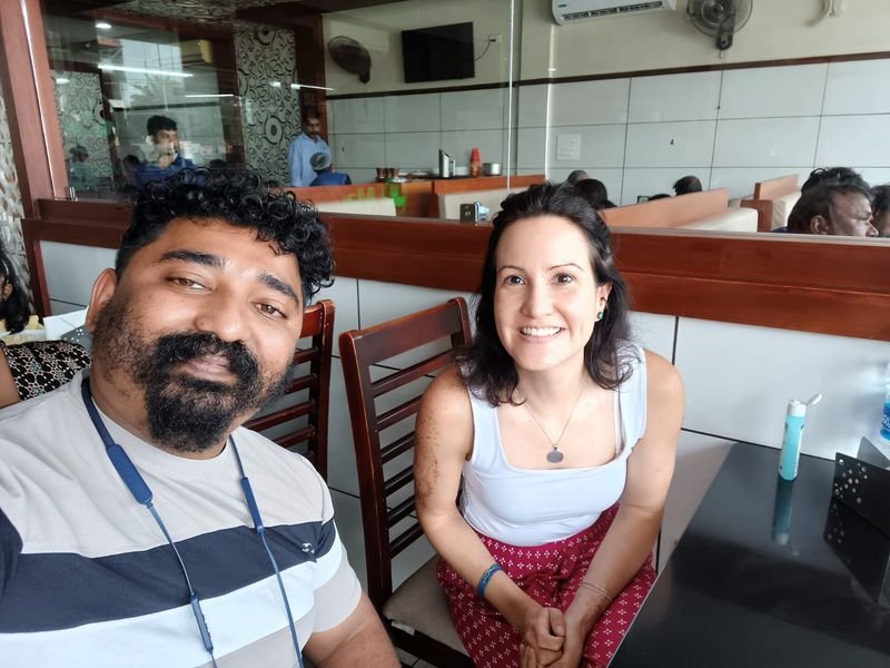 Driver Antony posing with foreign tourists at a restaurant