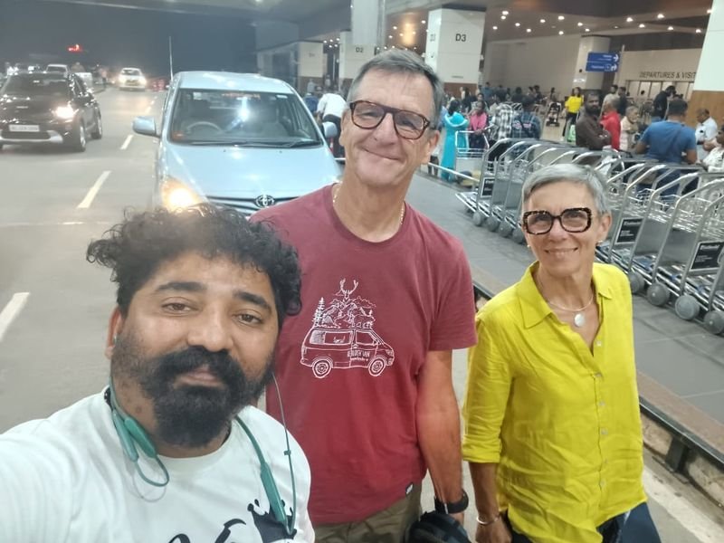 Driver Antony with foreign travellers at airport 2