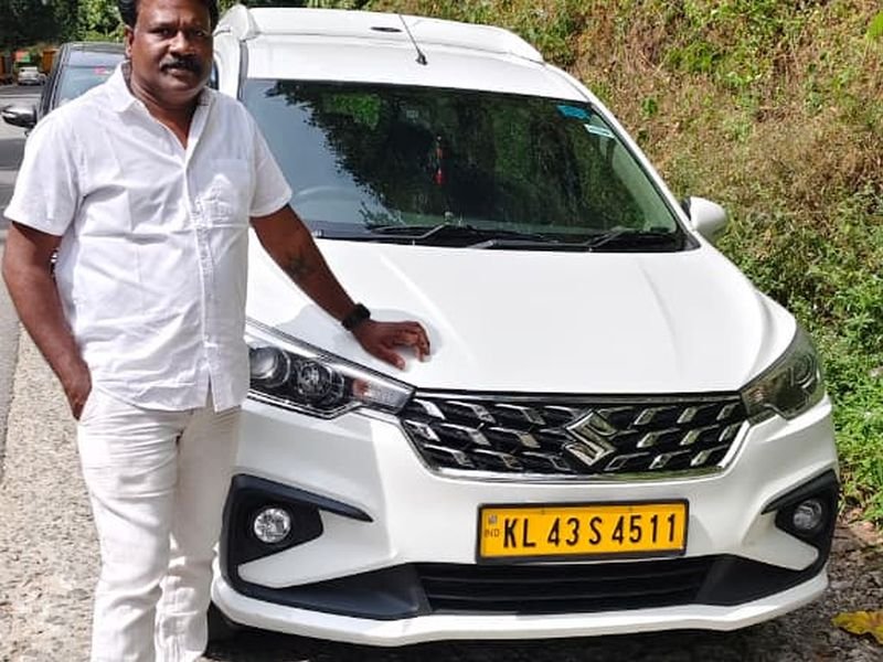 Driver posing near car
