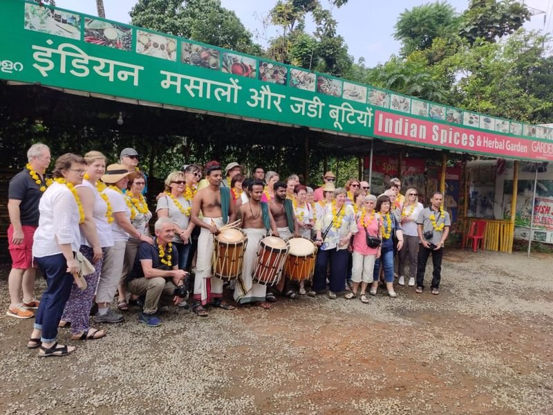 Foreign Travelers posing with Kerala Chenda melam team after a warm welcome
