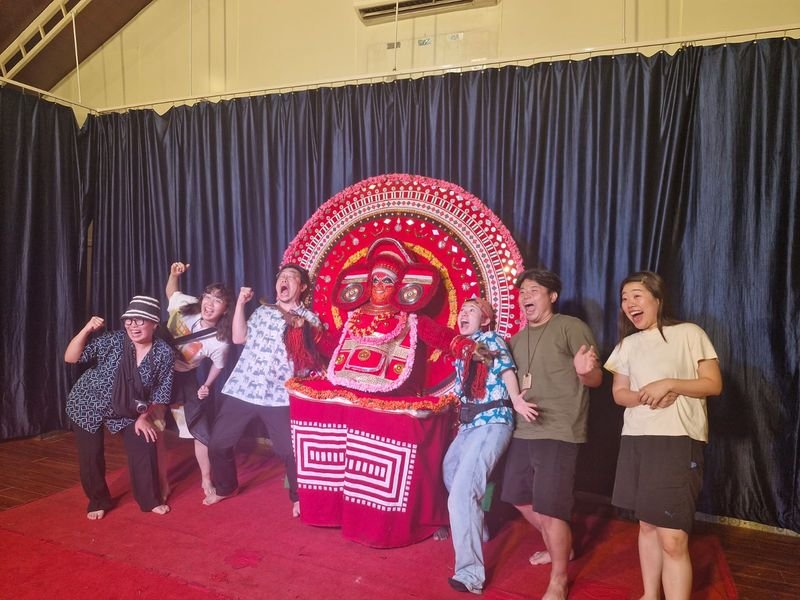 Foreign travelers in Group with Theyyam Art Form